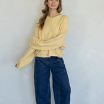 Full-body view of the Hailey Button Down Cardigan (Piper Cardigan) in honey styled with jeans