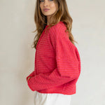 Woman wearing Hailey Button Down Cardigan in mini striped cherry red side view