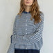 Woman wearing Hailey Button Down Cardigan in mini striped denim - front view