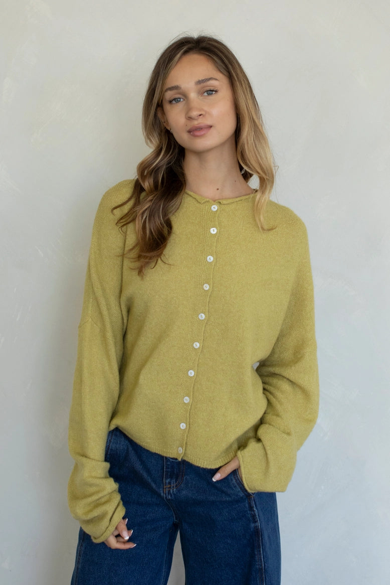 Front portrait of model wearing the Hailey Button Down Cardigan (Piper Cardigan) in moss