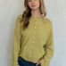 Front portrait of model wearing the Hailey Button Down Cardigan (Piper Cardigan) in moss