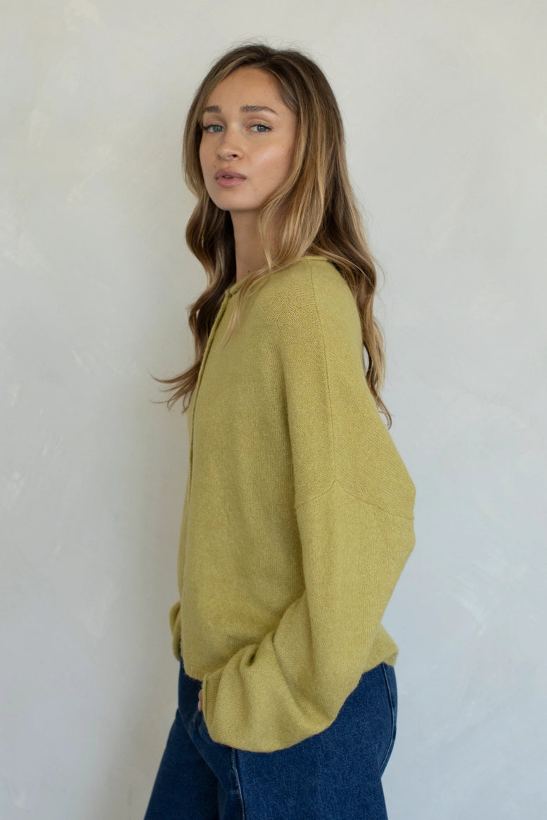 Side view of the Hailey Button Down Cardigan (Piper Cardigan) in moss highlighting drape and silhouette