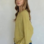 Side view of the Hailey Button Down Cardigan (Piper Cardigan) in moss highlighting drape and silhouette