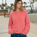 Model wearing the Hailey Button Down Cardigan in Peach for an easy everyday outfit