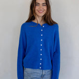 Woman wearing the Hailey Button Down Cardigan, also known as the Piper Cardigan, in blue — lightweight knit with button front.
