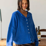 Woman wearing the blue Piper Cardigan (Hailey Button Down Cardigan) styled with skirt — cozy and chic everyday outfit.