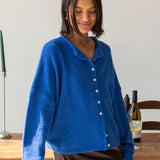 Woman wearing the blue Piper Cardigan (Hailey Button Down Cardigan) styled with skirt — cozy and chic everyday outfit.