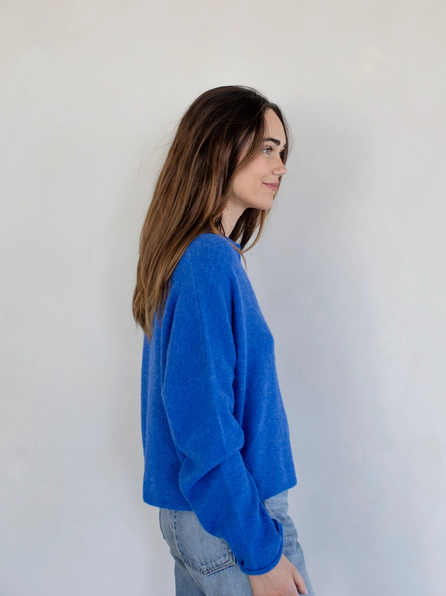 Side view of the Piper Cardigan, also called the Hailey Button Down Cardigan, in blue — relaxed fit and soft knit texture.