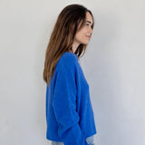 Side view of the Piper Cardigan, also called the Hailey Button Down Cardigan, in blue — relaxed fit and soft knit texture.