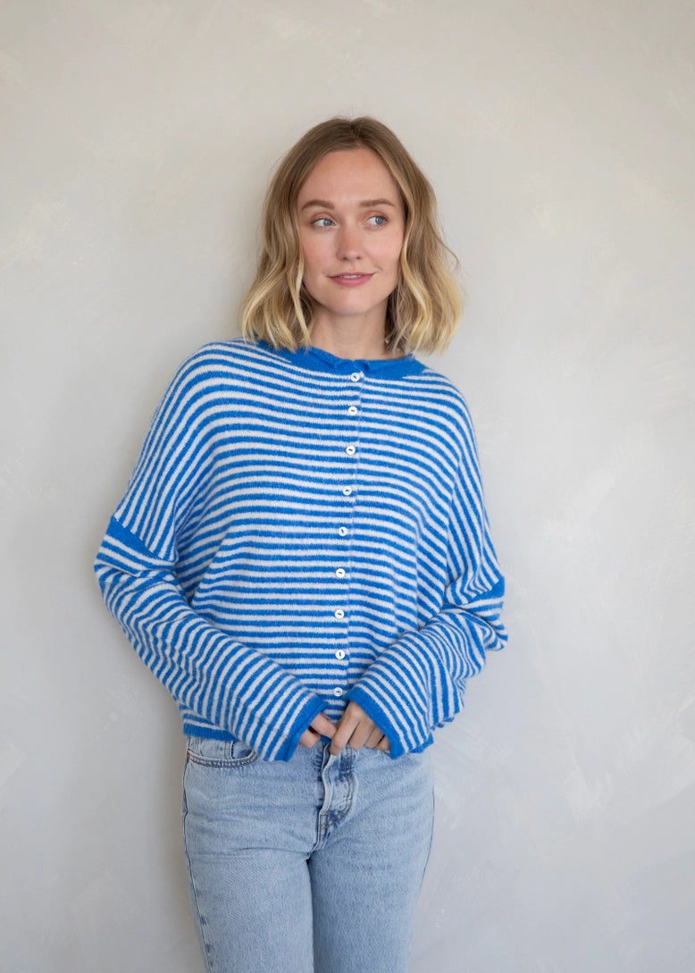 Woman wearing the Hailey Button Down Cardigan, also known as the Piper Cardigan, in mini striped blue — soft knit with button front.