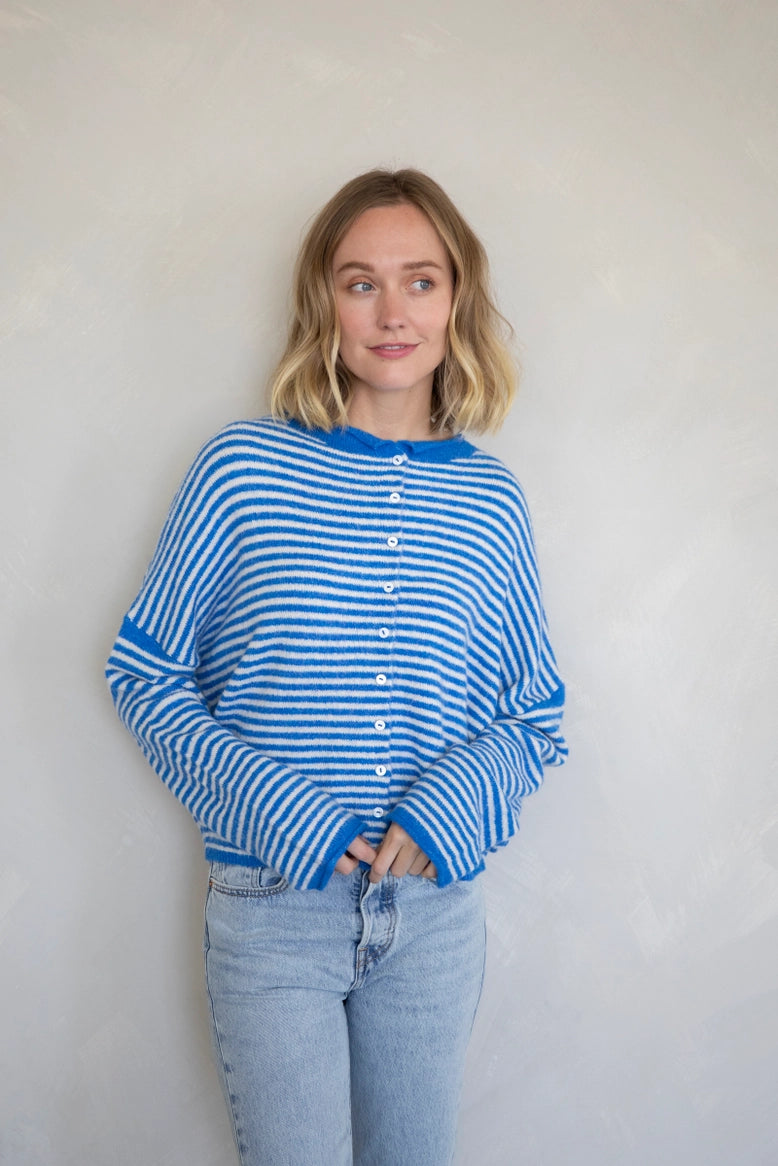 Woman wearing the Hailey Button Down Cardigan, also known as the Piper Cardigan, in mini striped blue — soft knit with button front.
