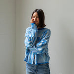 Woman wearing the mini striped blue Piper Cardigan (Hailey Button Down Cardigan) — soft, casual women’s knit sweater.