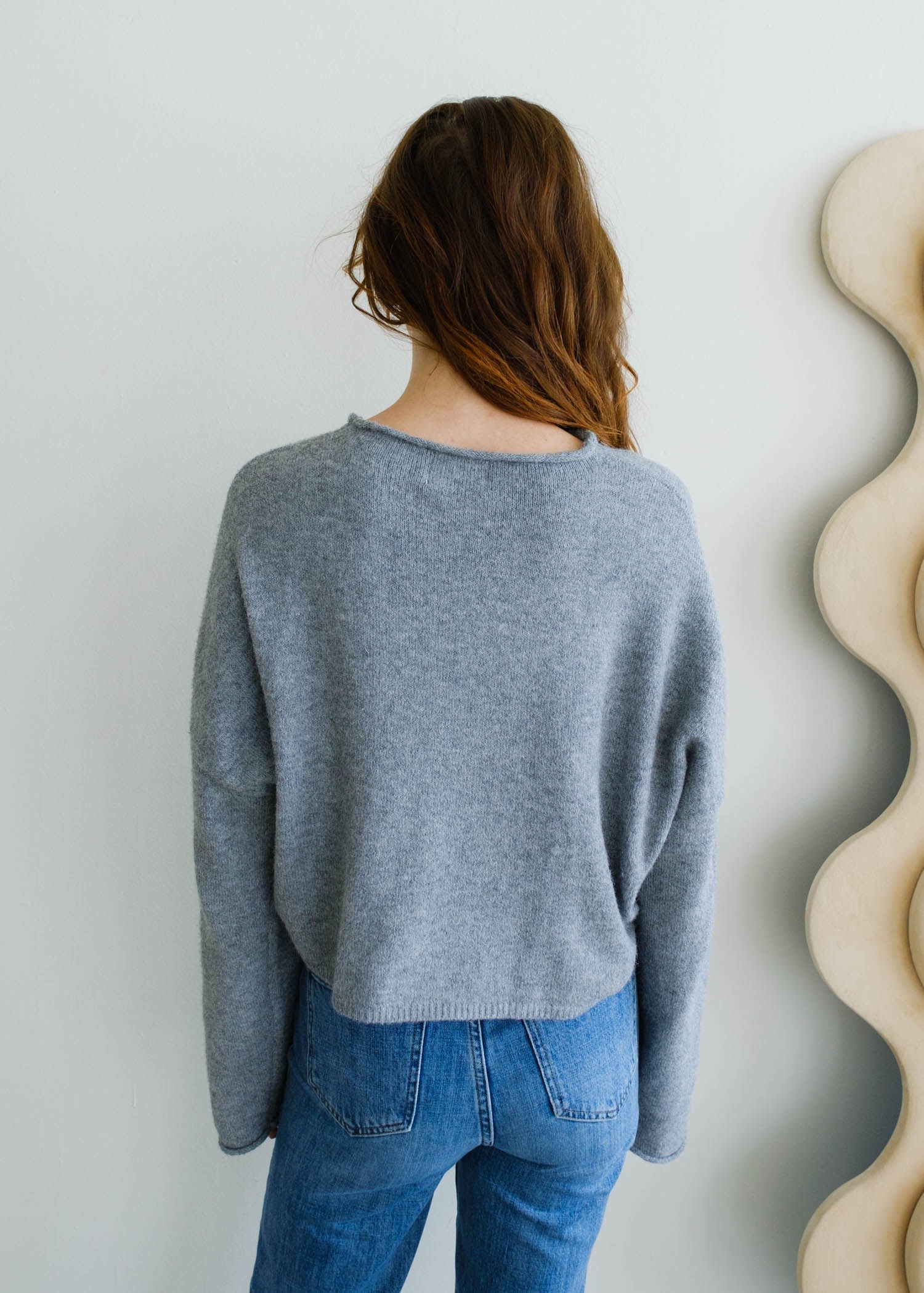 Back view of the Piper Cardigan in heather grey highlighting classic silhouette