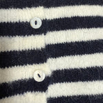 Close-up detail of the navy stripe knit texture and button finish