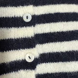 Close-up detail of the navy stripe knit texture and button finish