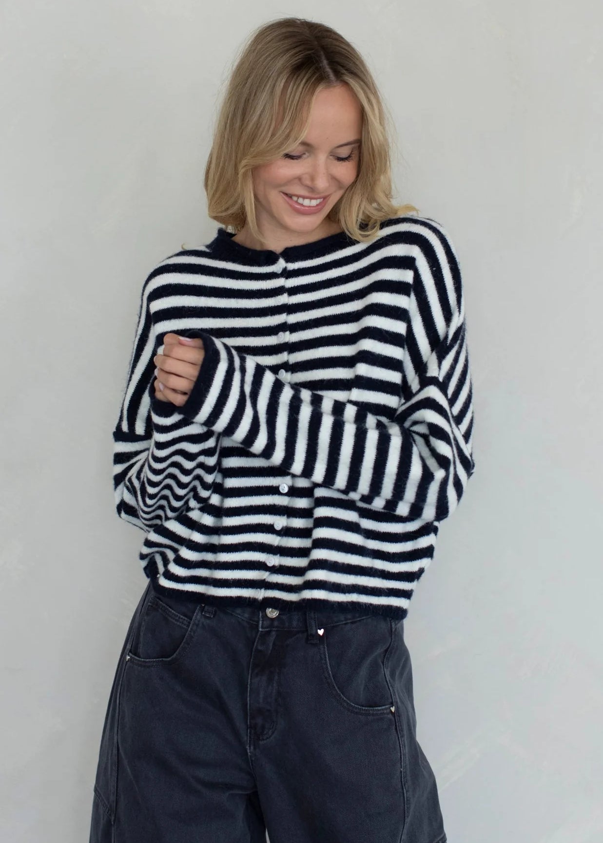 Front portrait of model wearing the Hailey Button Down Cardigan (Piper Cardigan) in navy striped