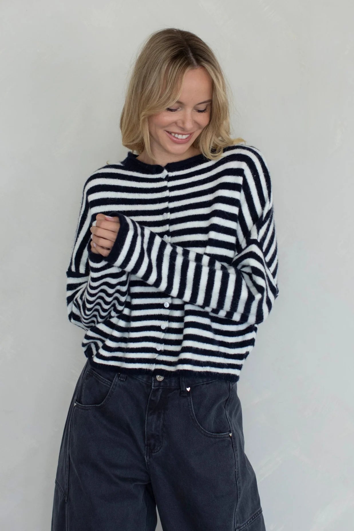 Front portrait of model wearing the Hailey Button Down Cardigan (Piper Cardigan) in navy striped