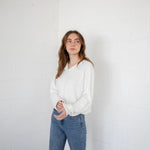 Woman is wearing the Hailey Button Down Cardigan (Piper Cardigan) in off-white paired with jeans