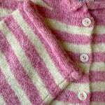 Close-up of the Hailey Button Down Cardigan in Striped Bubblegum showing the soft knit texture, buttons, and pink stripe detail