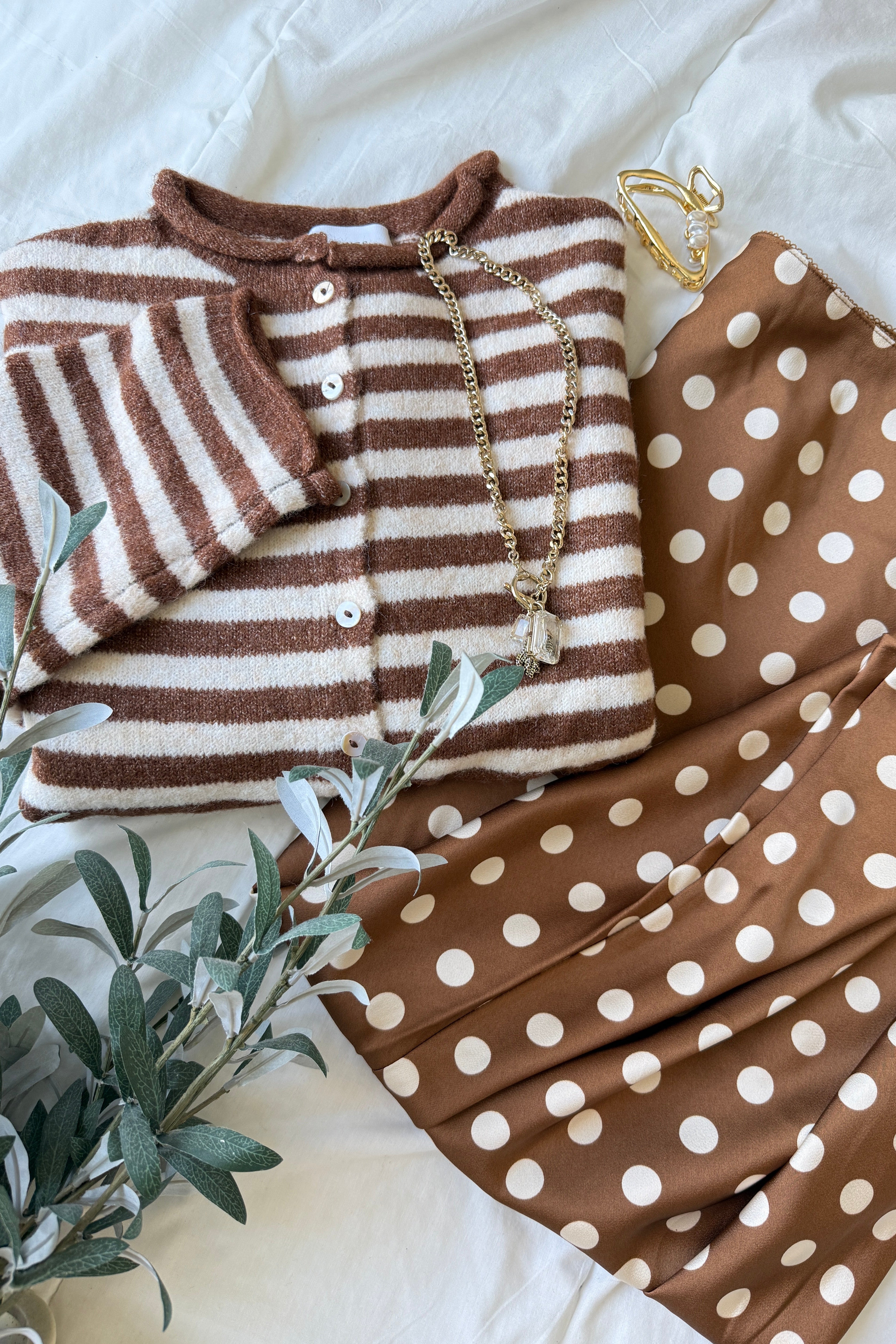 Hailey Button Down Cardigan in Ivory Brown Stripe styled in a flatlay with a polka dot skirt and gold accessories, cozy everyday outfit idea