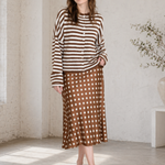 Woman wearing the Hailey Button Down Cardigan in Ivory Brown Stripe with a polka dot skirt, styled as an easy everyday outfit