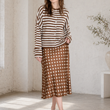 Woman wearing the Hailey Button Down Cardigan in Ivory Brown Stripe with a polka dot skirt, styled as an easy everyday outfit