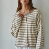 Woman wearing a striped Hailey Button Down cardigan against a plain background