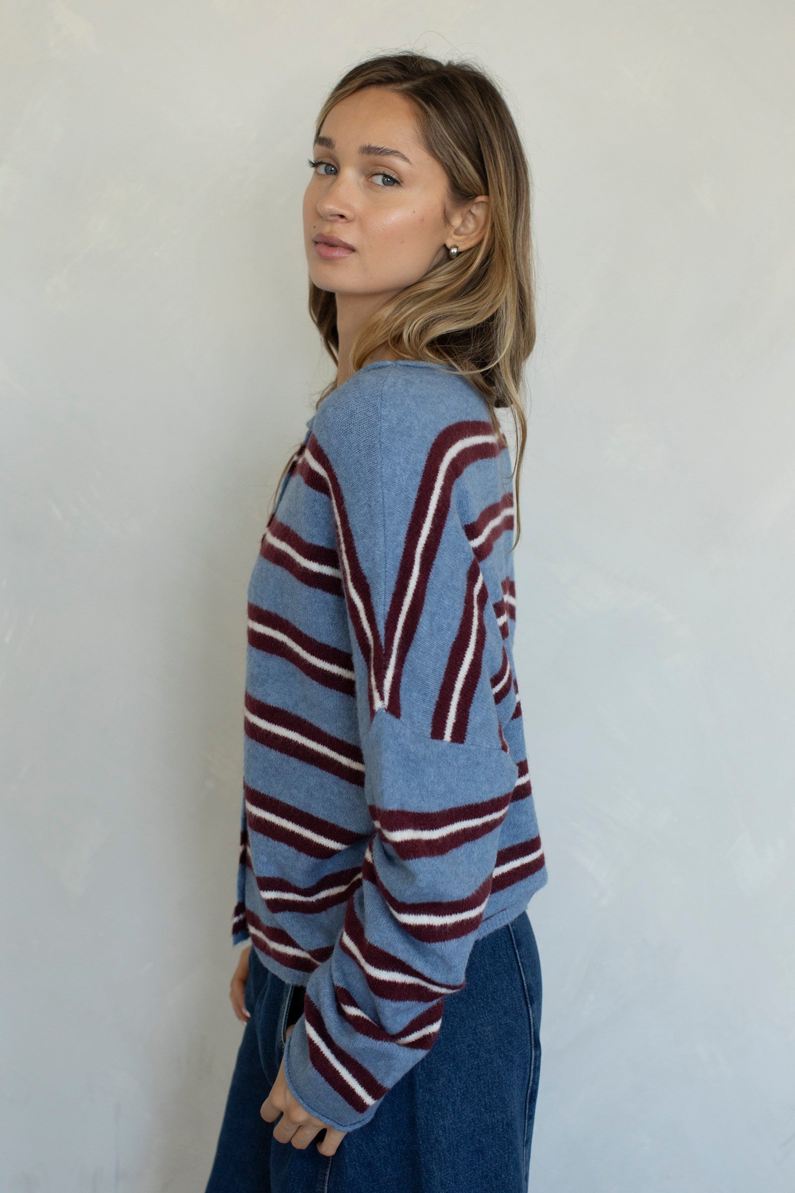 Side view of the Hailey Button Down Cardigan in Varsity Striped Dusty Blue