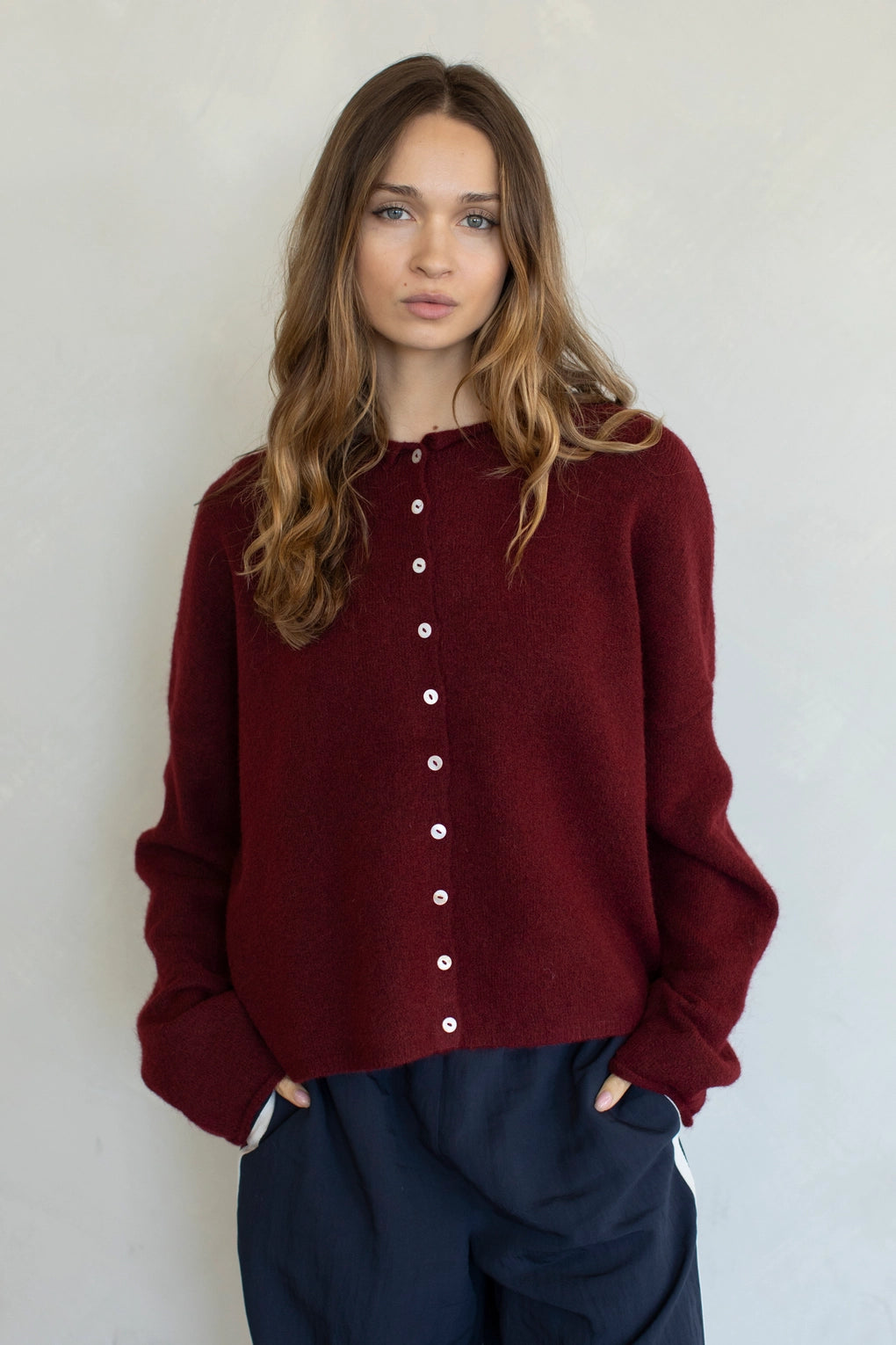 Woman wearing Hailey Button Down Cardigan in burgundy wine front view