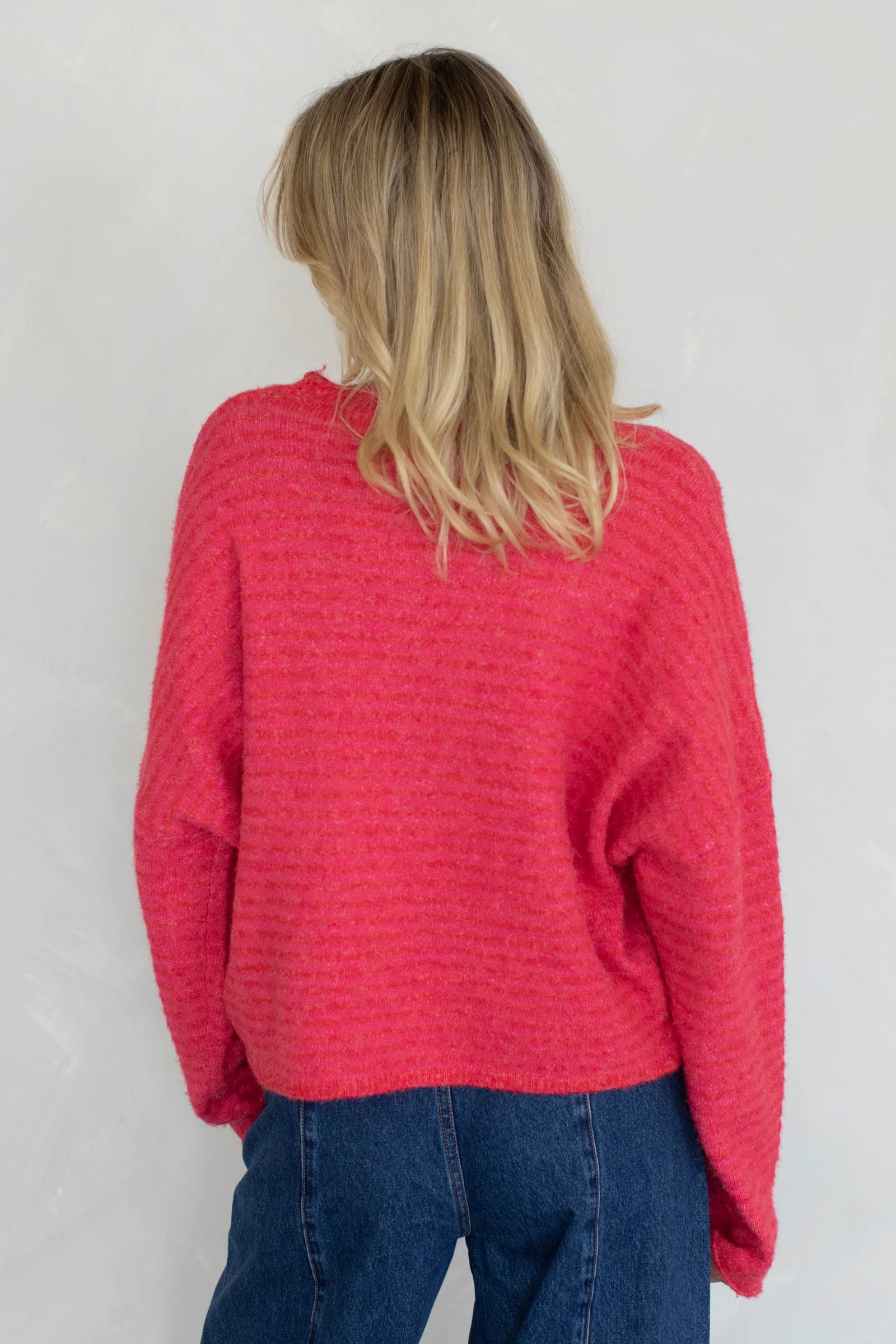 Back view of cherry red mini striped Hailey cardigan with soft lightweight knit