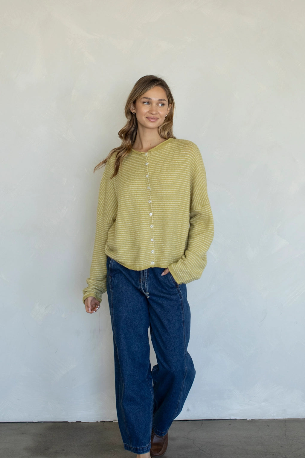 Woman wearing honey pin striped Hailey cardigan styled with casual outfit and relaxed fit