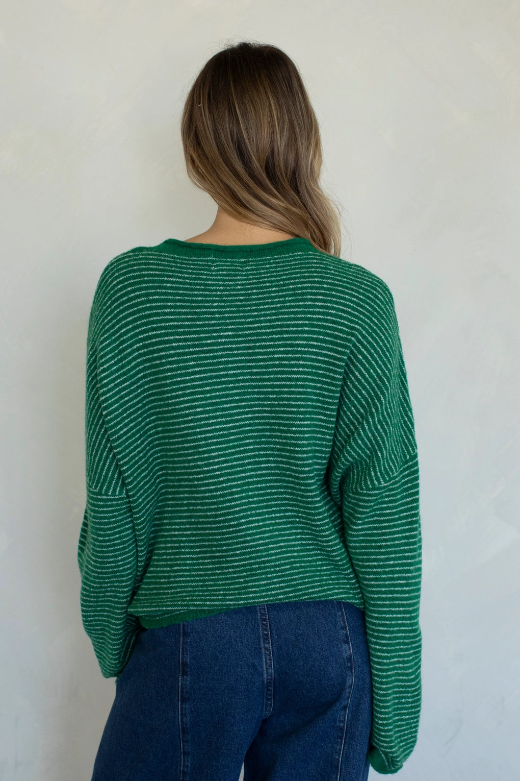 Back view of kelly green pin striped Hailey cardigan with soft lightweight knit