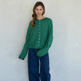 Woman wearing kelly green pin striped Hailey cardigan styled with casual outfit and relaxed fit