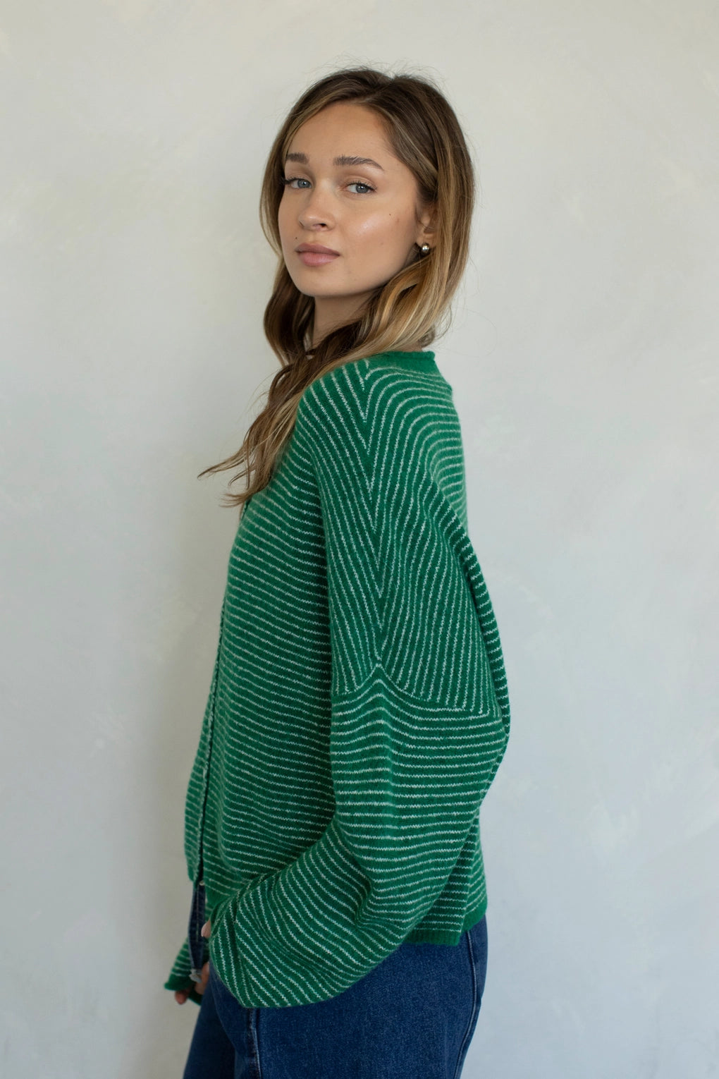 Side view of Hailey cardigan in kelly green pin stripe lightweight knit relaxed fit