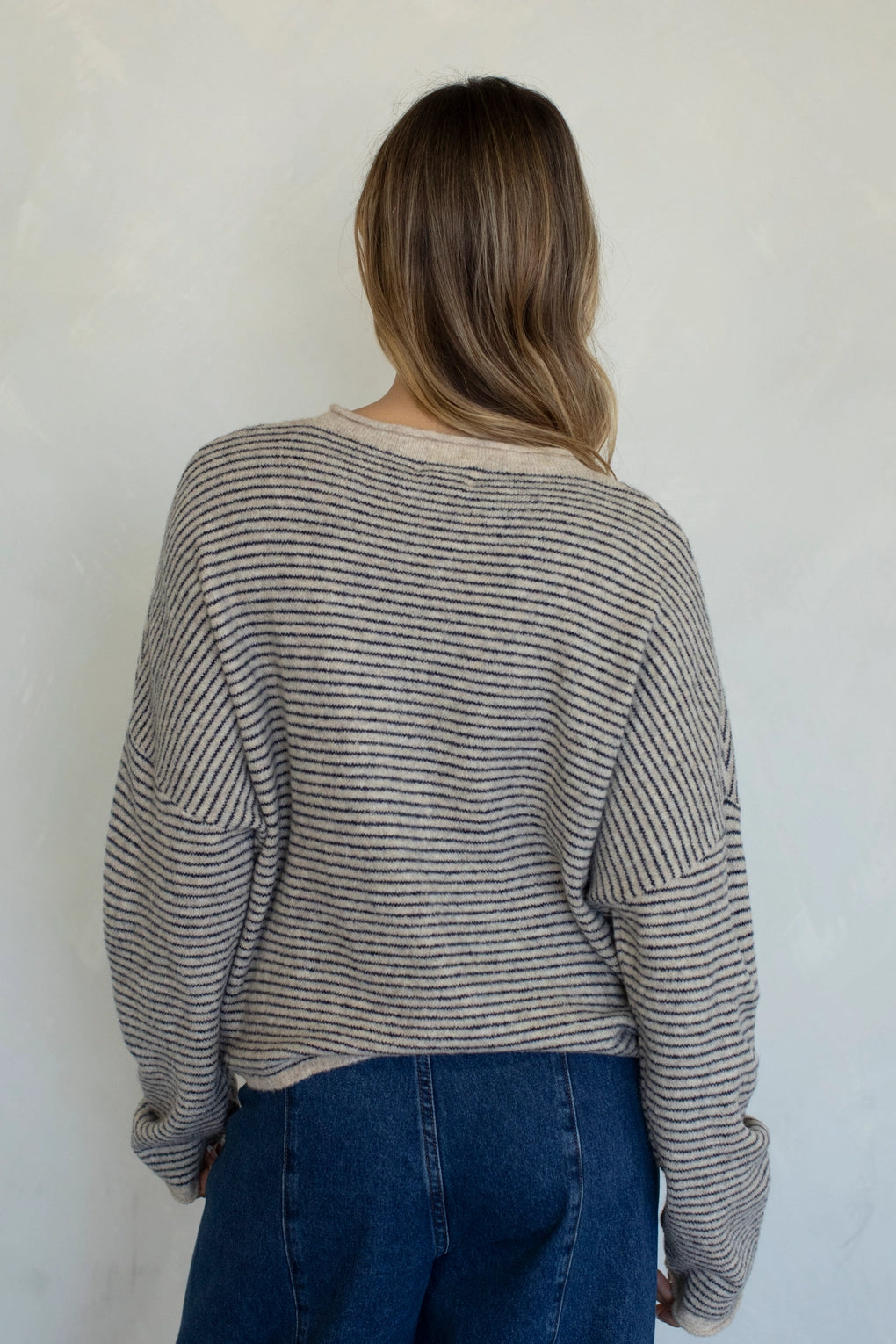 Back view of natural pin striped Hailey cardigan with soft lightweight knit