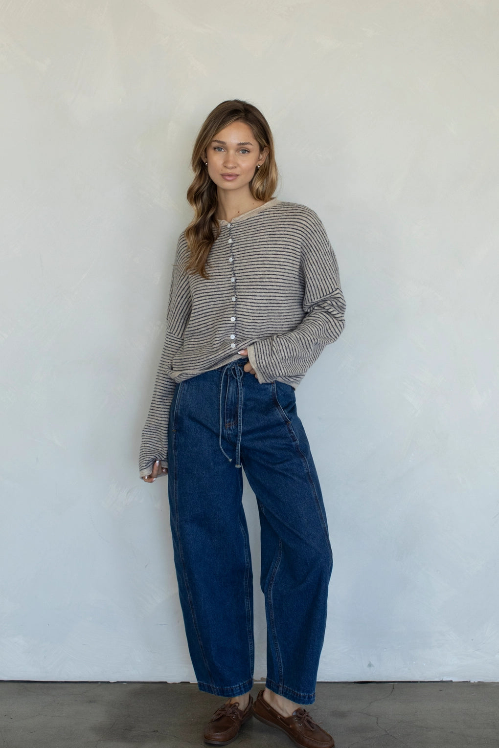 Woman wearing natural pin striped Hailey cardigan styled with casual outfit and relaxed fit