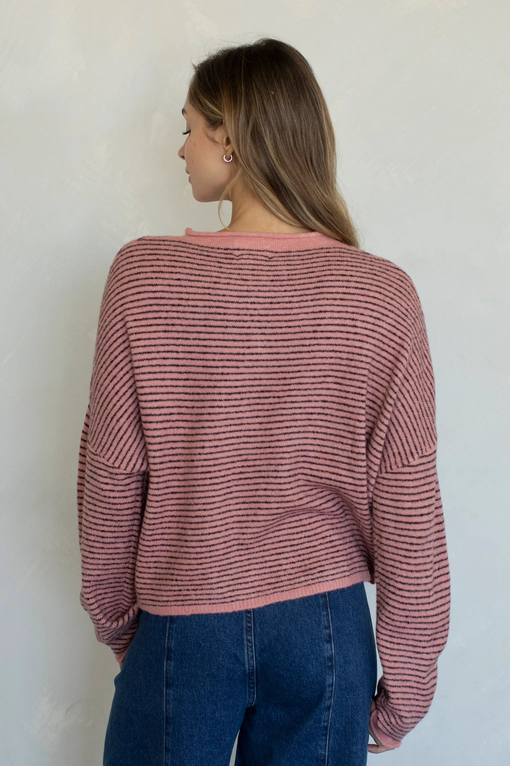Back view of rose pin striped Hailey cardigan with soft lightweight knit
