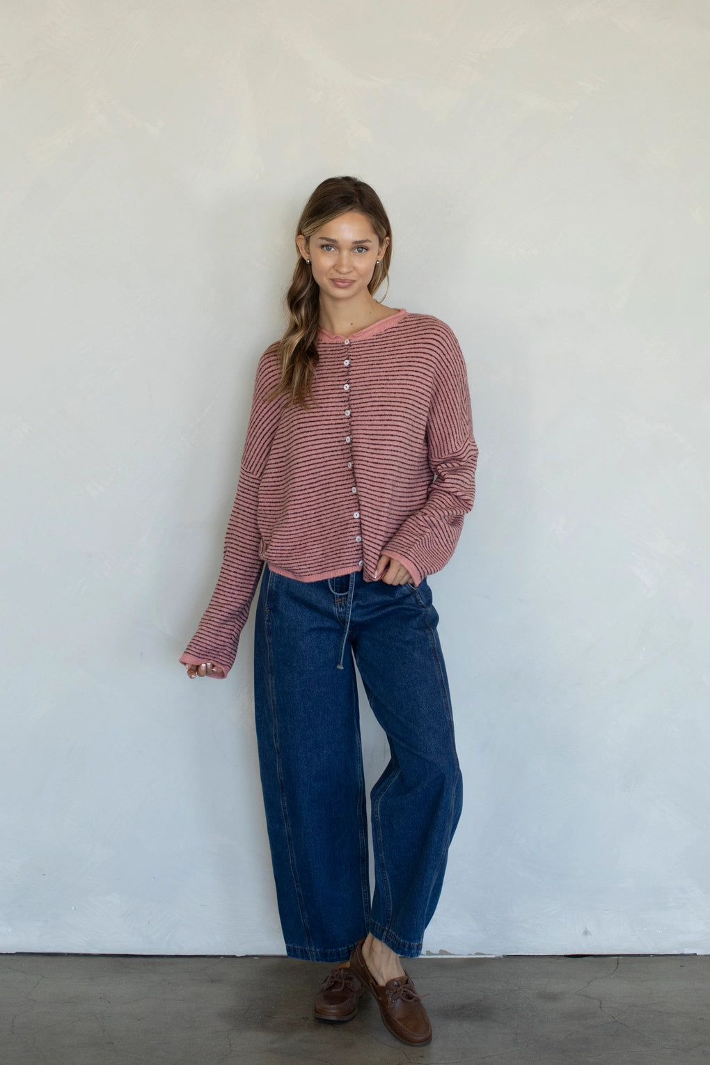 Woman wearing rose pin striped Hailey cardigan styled with casual outfit and relaxed fit