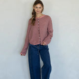 Woman wearing rose pin striped Hailey cardigan styled with casual outfit and relaxed fit