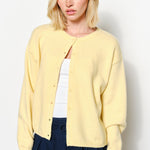 Close-up of the Harper Round-Neck Relaxed Cardigan in butter yellow showing button details and soft knit texture.