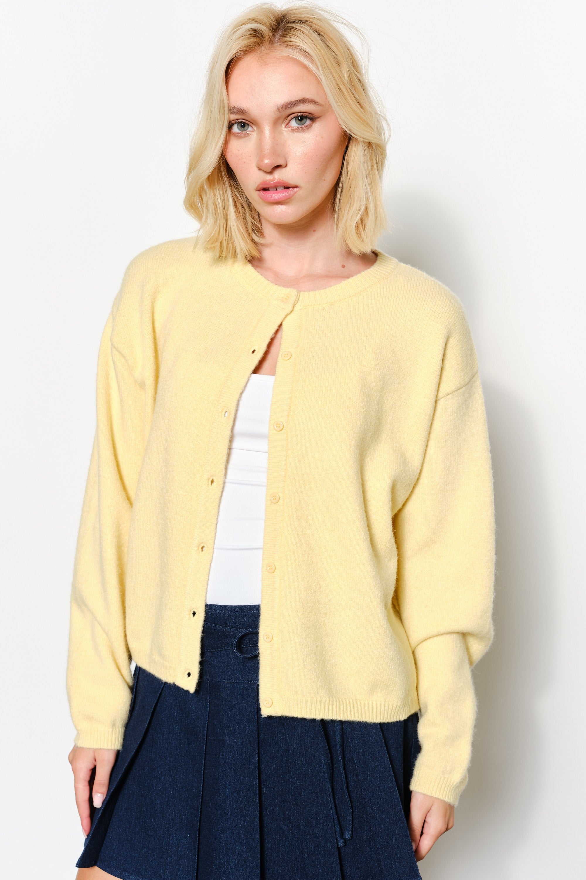 Close-up of the Harper Round-Neck Relaxed Cardigan in butter yellow showing button details and soft knit texture.