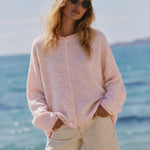 Close-up front view of the Hailey Mini Striped Pink Button Down Cardigan styled on model