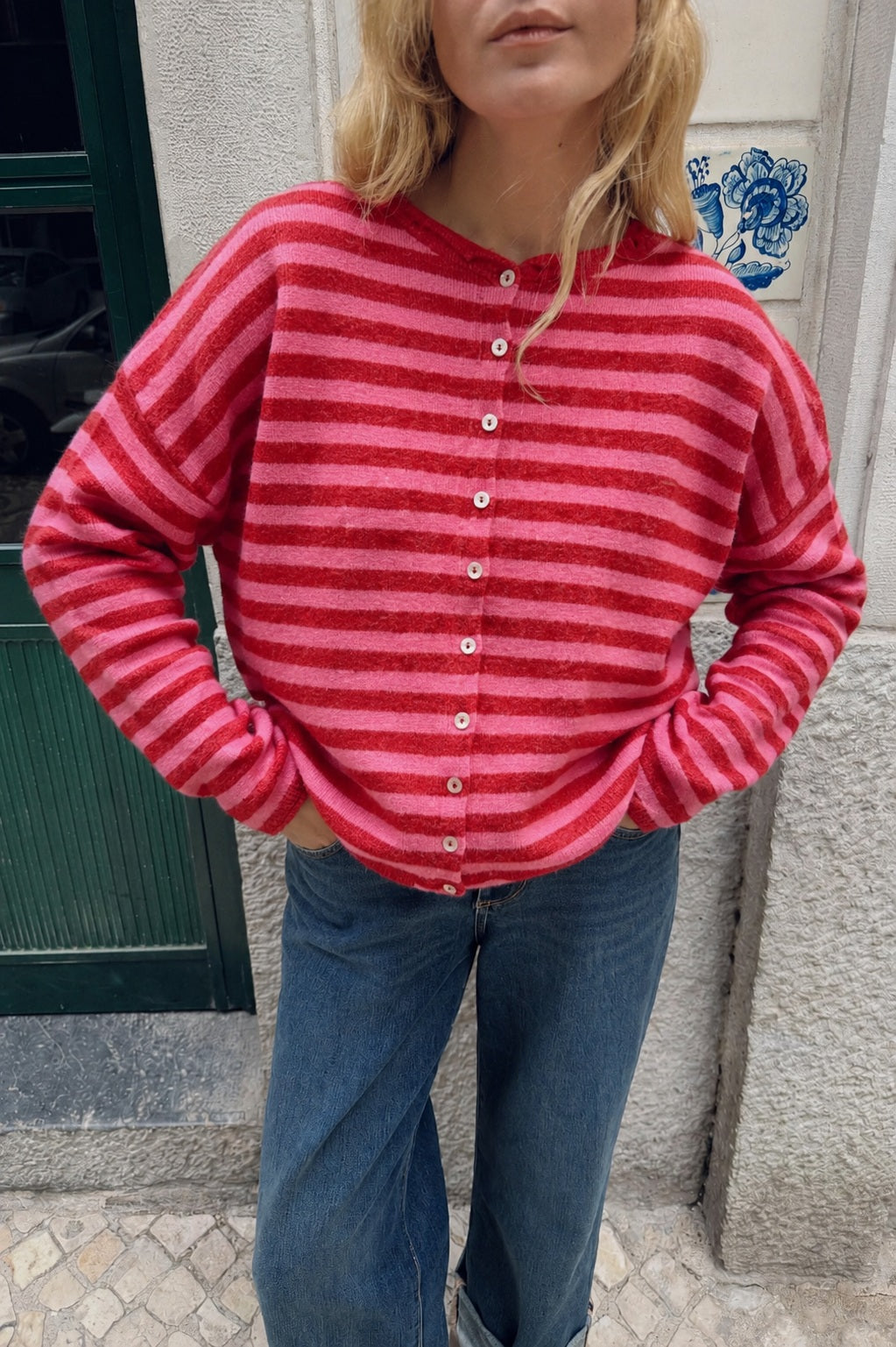 Model wearing the Hailey Red Combo striped cardigan styled with casual denim.