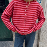 Model wearing the Hailey Red Combo striped cardigan styled with casual denim.