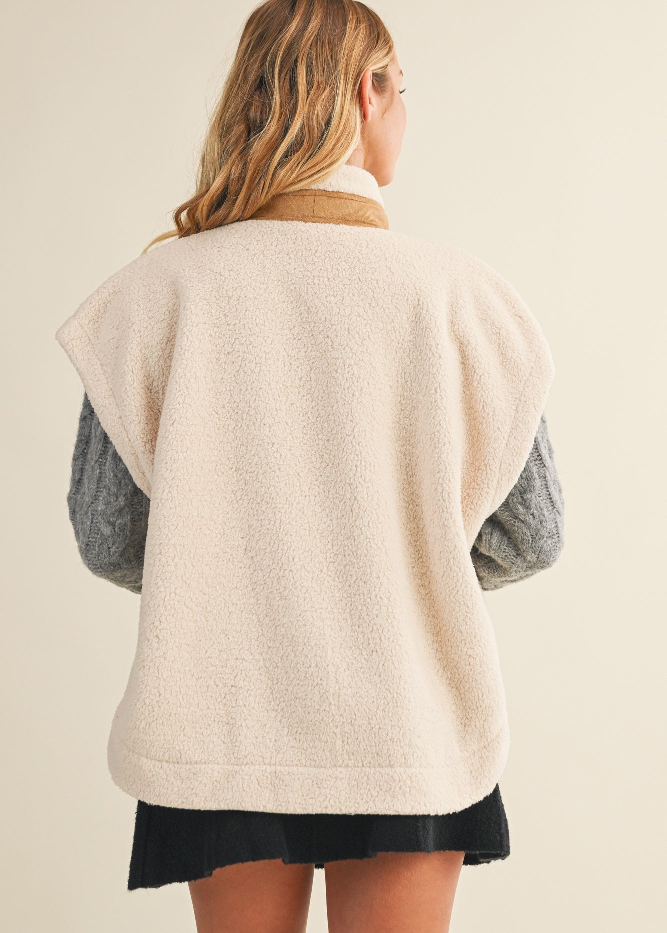 Back view of the ecru cozy snap vest showing the sleeveless silhouette and relaxed fit