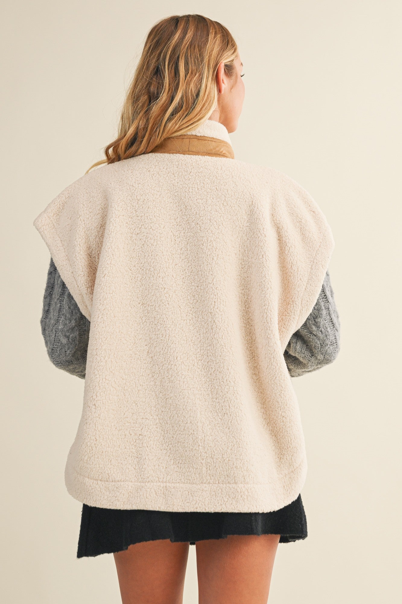 Back view of the ecru cozy snap vest showing the sleeveless silhouette and relaxed fit