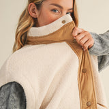 Close-up of the mock neck and snap-front detail on the Harper Cozy Snap Vest in ecru