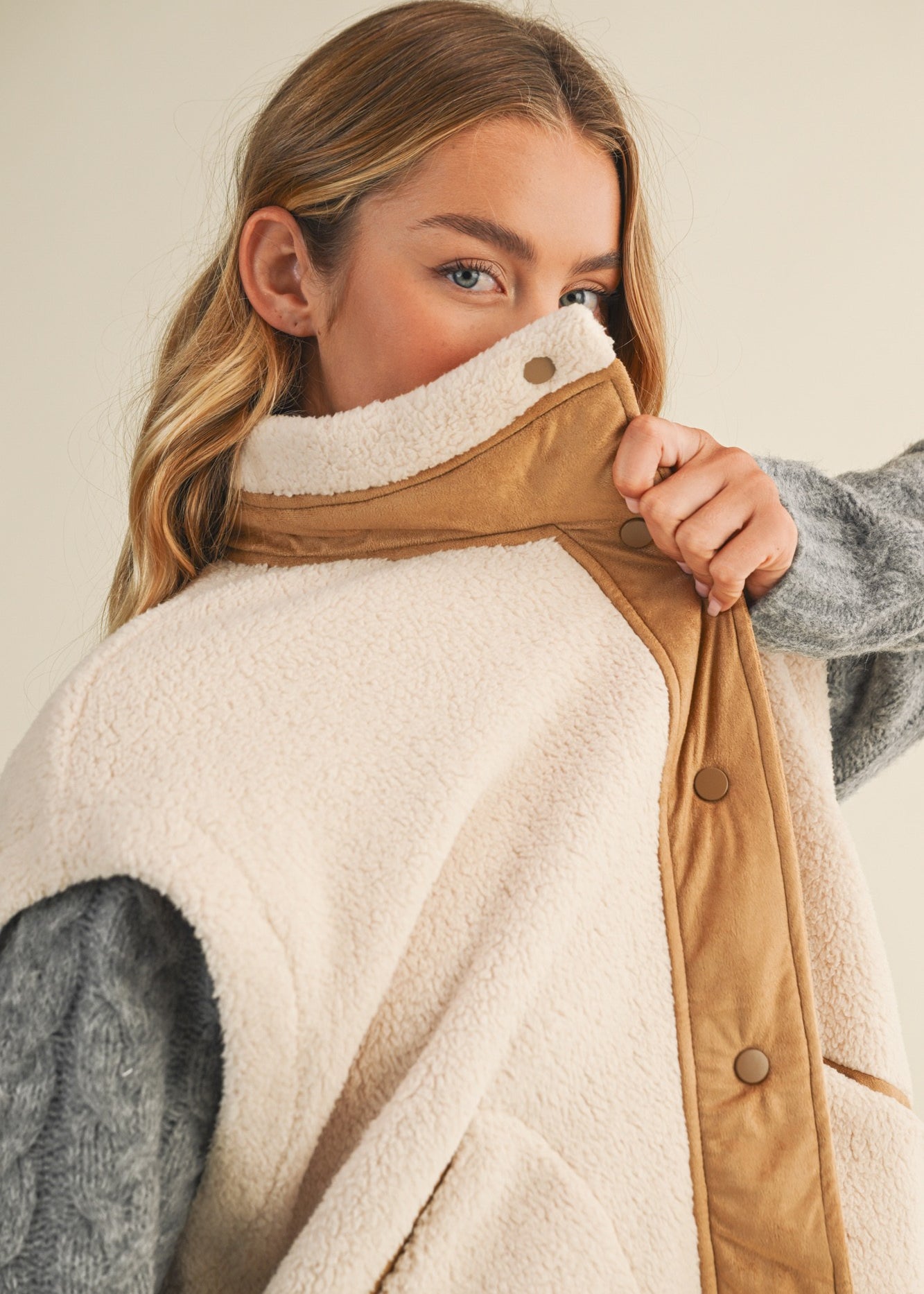 Close-up of the mock neck and snap-front detail on the Harper Cozy Snap Vest in ecru