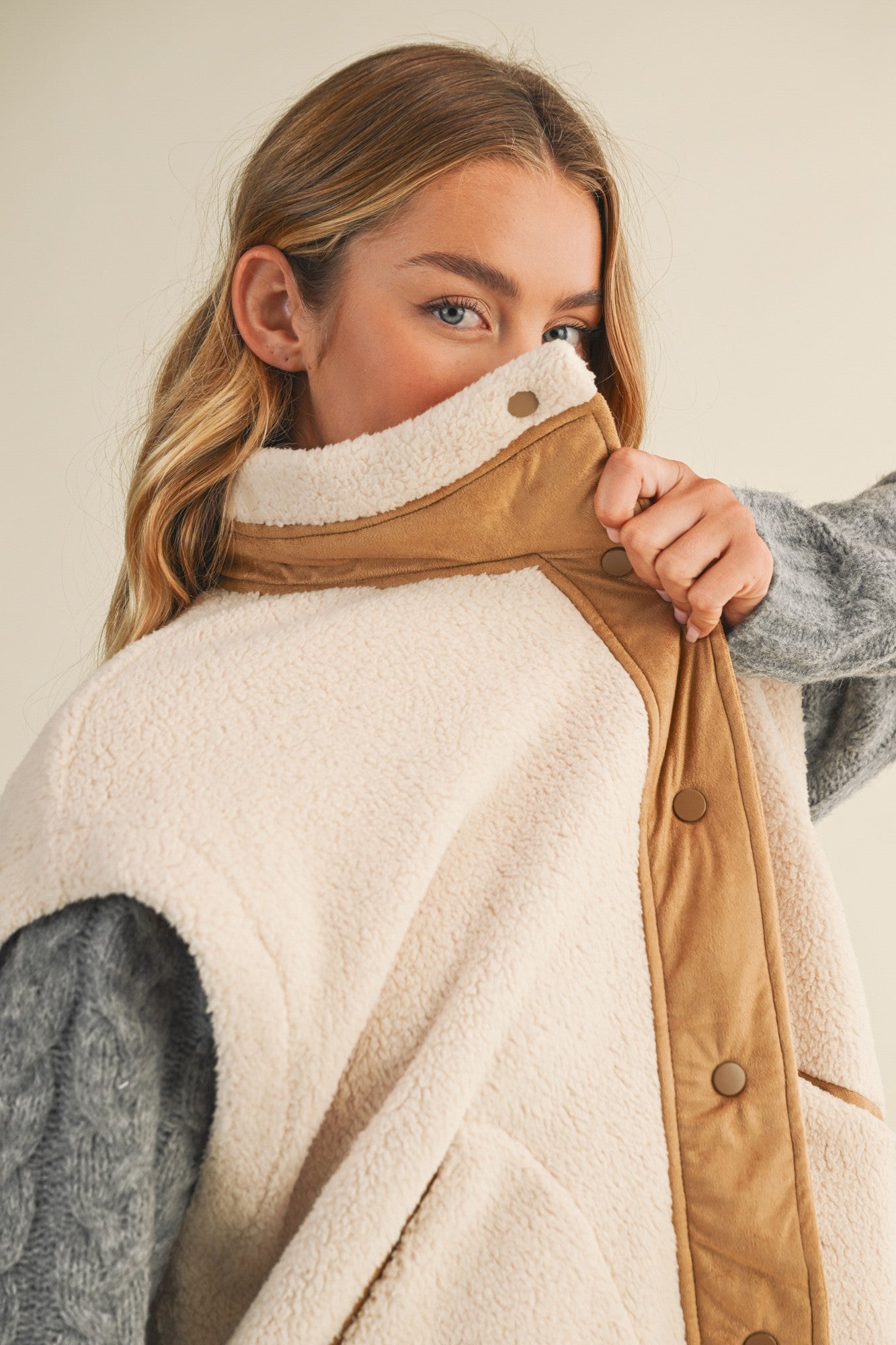 Close-up of the mock neck and snap-front detail on the Harper Cozy Snap Vest in ecru