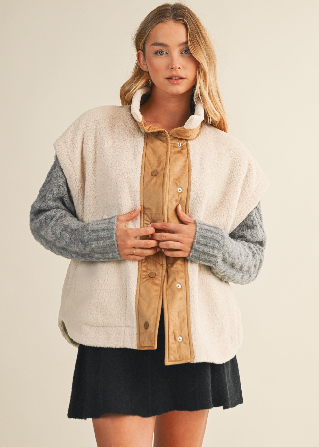 Front lifestyle view of model wearing the Harper Cozy Snap Vest in ecru with mock neck and snap closure